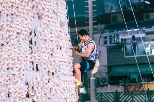 A man participating in the Bun Scrambling Competition during Hong Kong's Cheung Chau Bun Festival